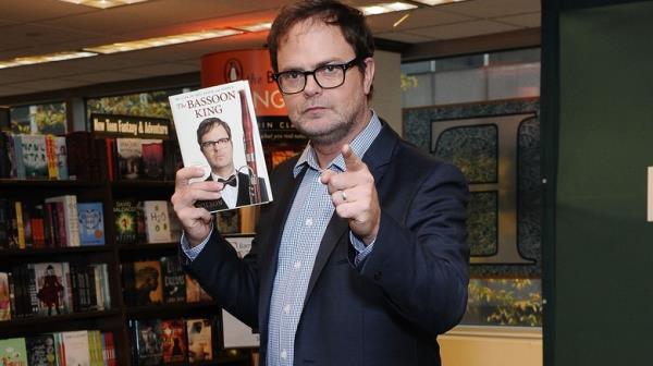 Rainn Wilson holding his book The Bassoon King