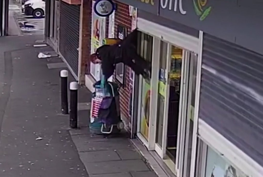 Woman is left dangling from Best One shop shutters in Tonteg